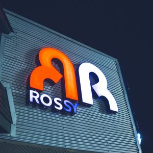 a close up of a neon sign on the side of a building