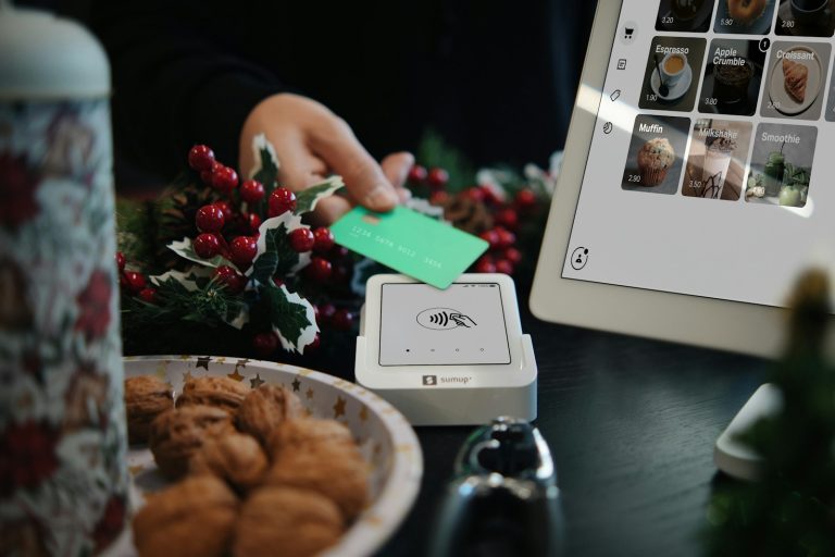 A table with a plate of food and a laptop on it