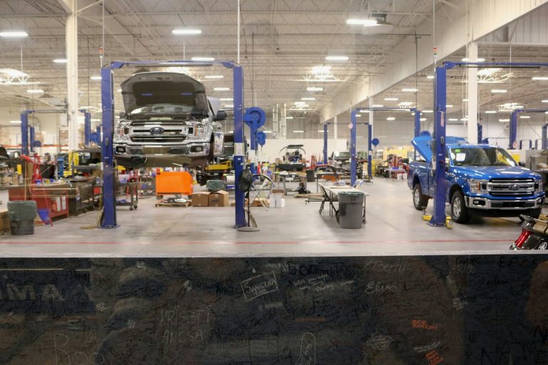 black car in a garage; Auto repair and car maintenance marketing