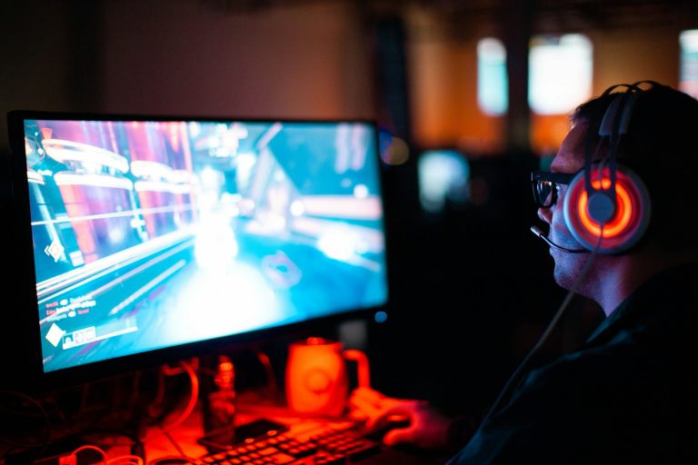 person using computer playing FPS game; marketing Mobile Apps and Gaming